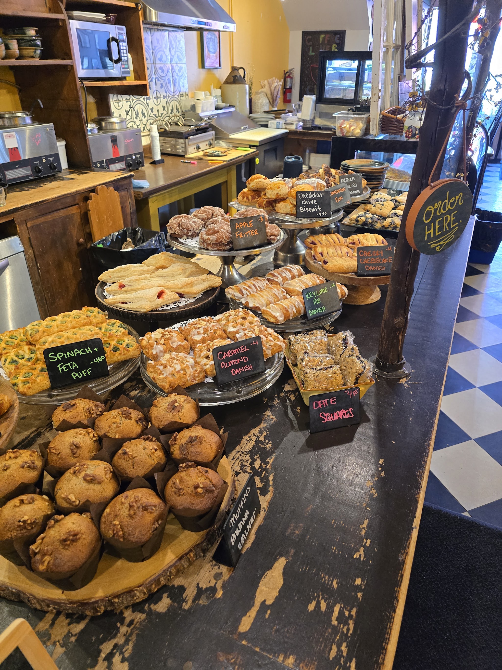 Baked goods counter with muffins, scones, and pies
