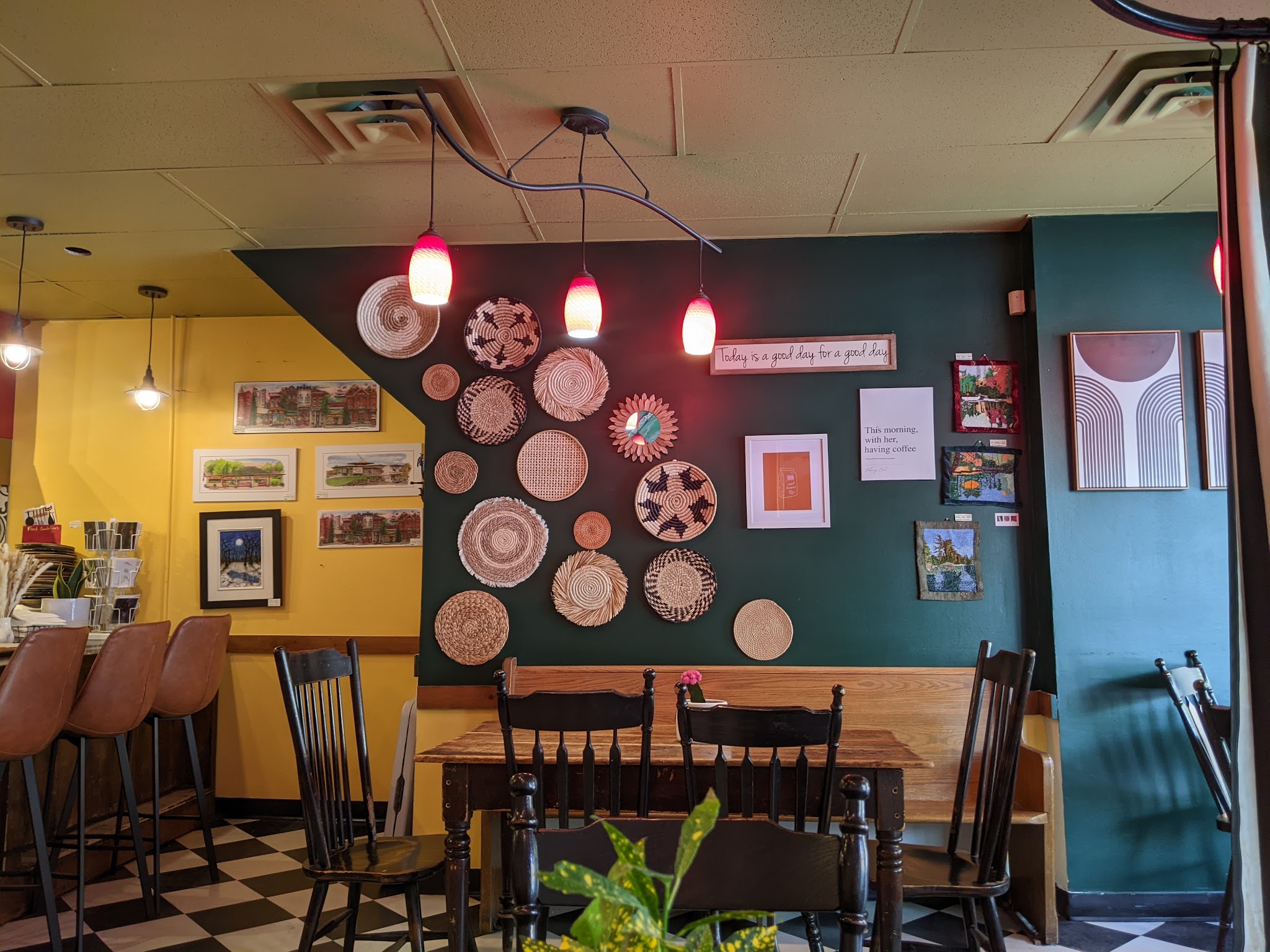 Inside Apple Annie's Cafe with warm lighting, woven wall art, and cozy seating
