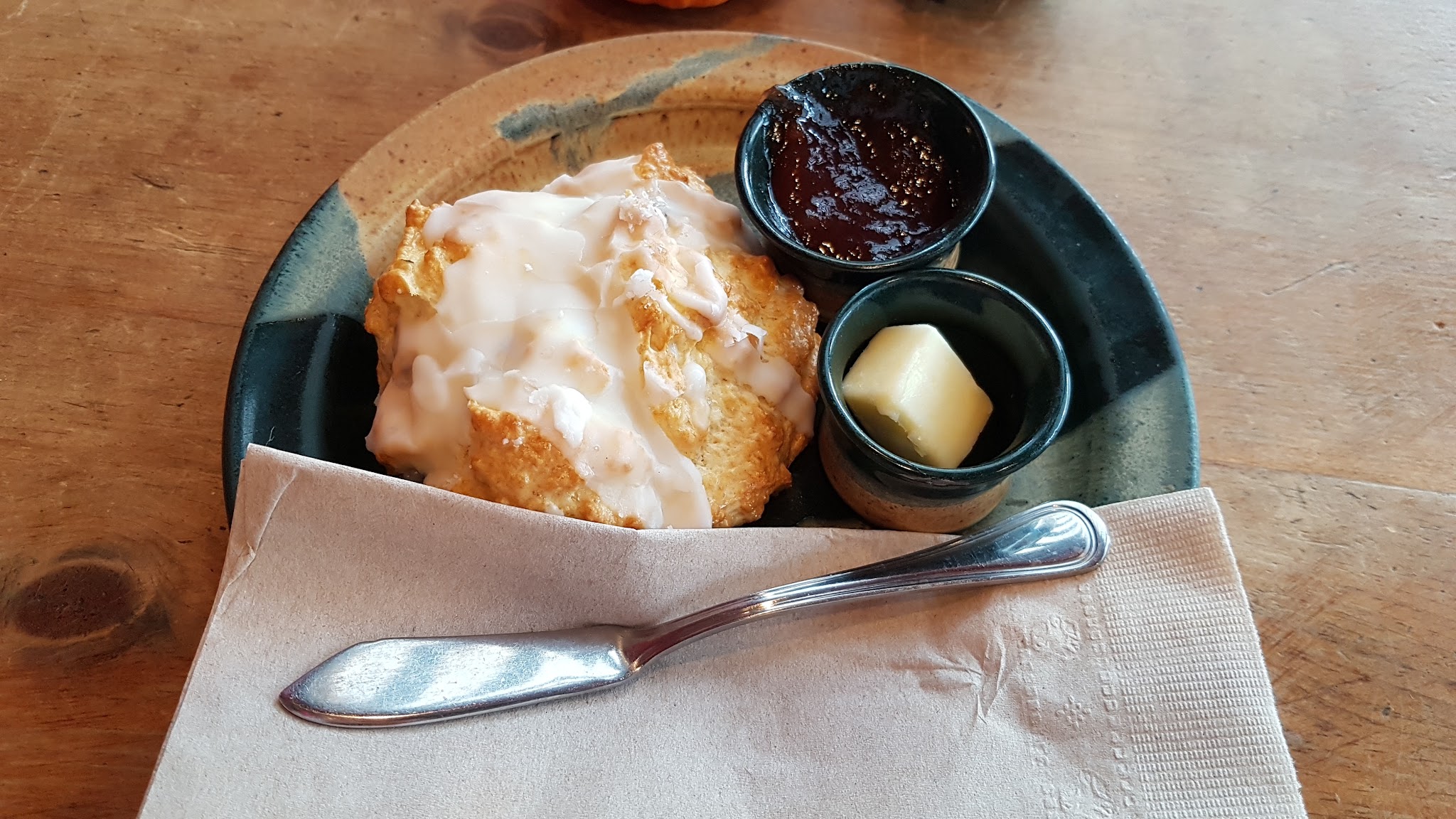 Homemade scone with icing and jam