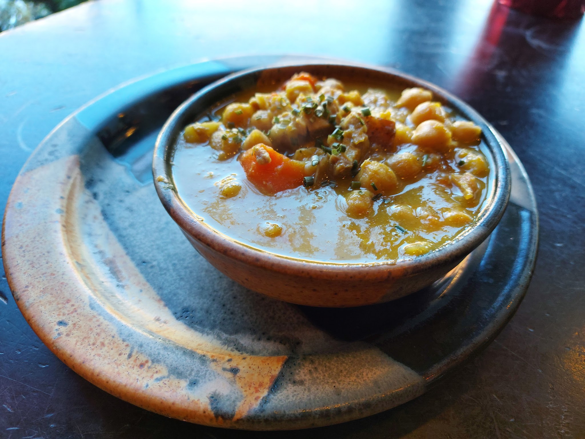 Bowl of hearty chickpea soup on handmade pottery